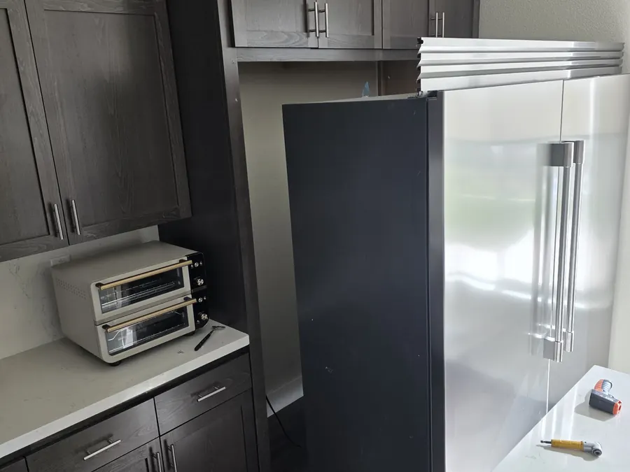 GE Monogram built-in refrigerator in a kitchen during compressor relay repair