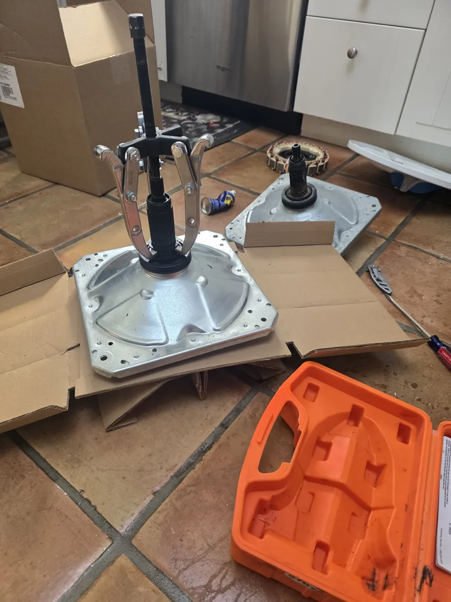 Bearing puller on an LG washer drum during bearing removal
