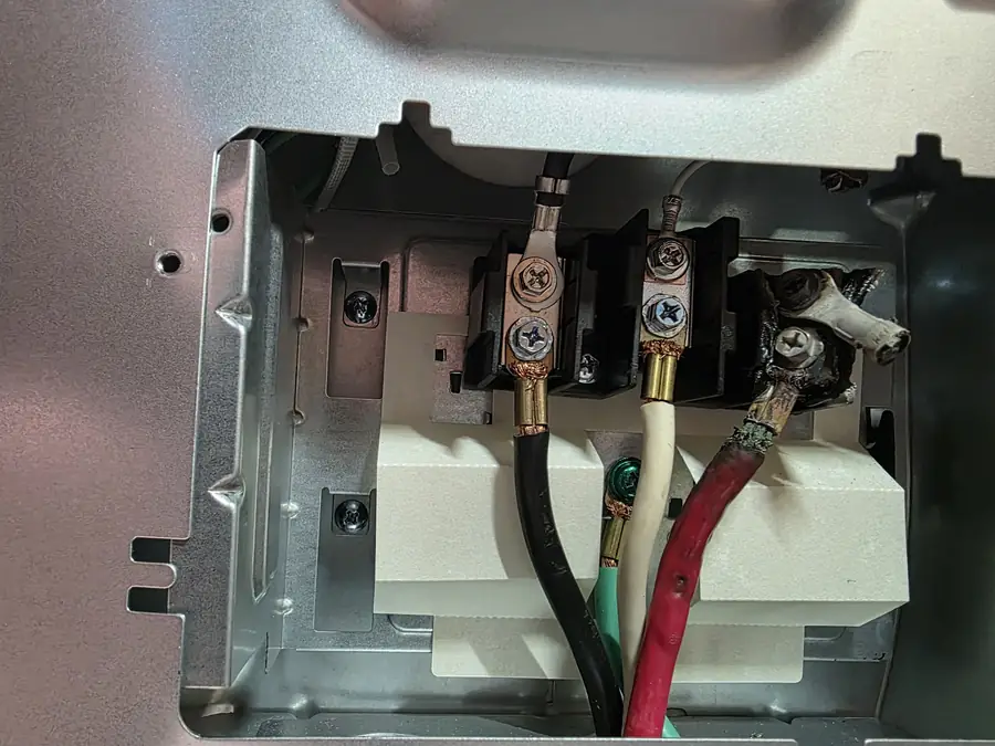 Burned wire terminal block on the back of an electric range