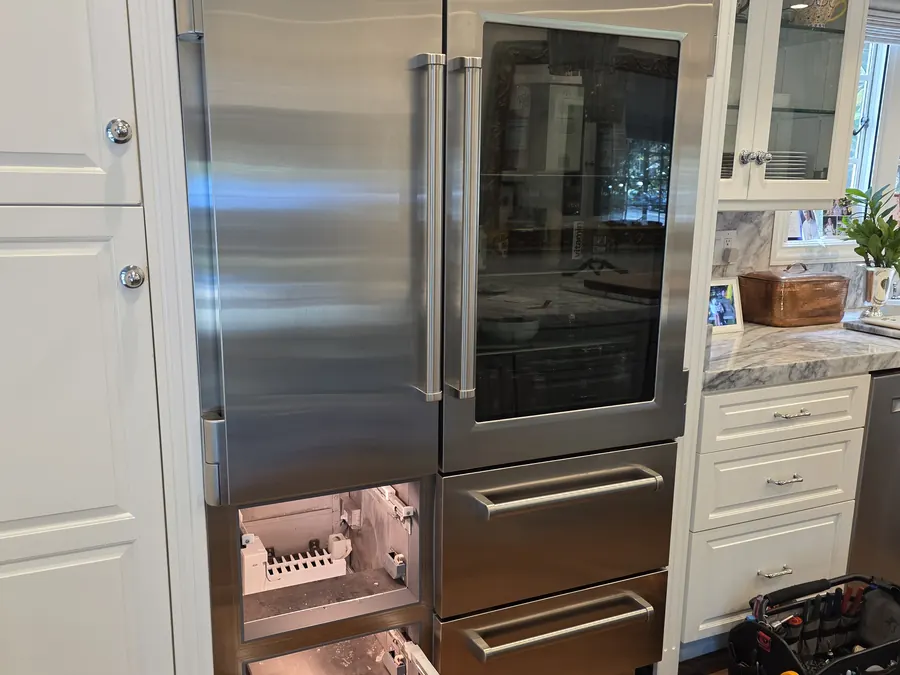 Sub-Zero built-in refrigerator with glass door during a defrost system rebuild